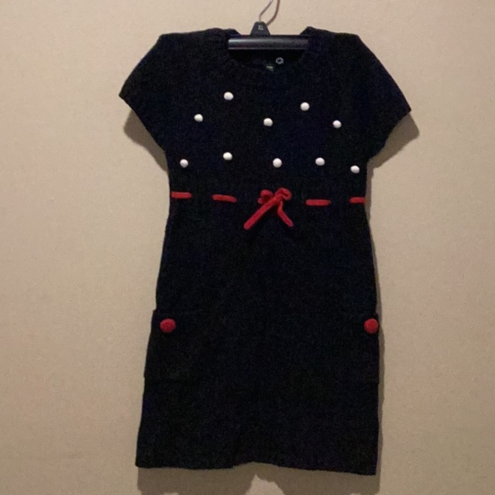 Daisy girls black sweater dress. Size 4.Small poms on top with red waist ribbon.